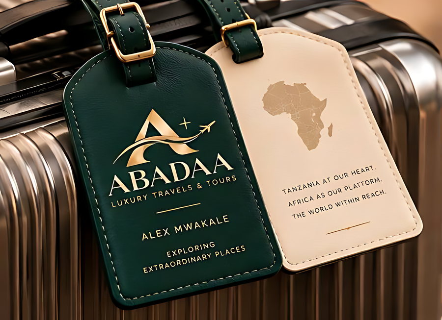Two monogram luggage tags, one green and one cream, on a suitcase